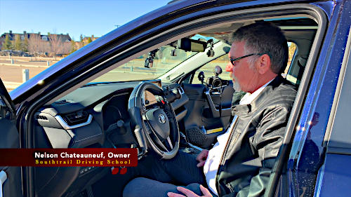 Nelson Chateauneuf of Southtrail Driving School demonstrate the controls available to drivers with diabilities.