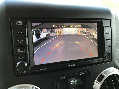 You can use a backup camera for your driver's test. Check it as you would your mirrors, however, you'll still be looking out the rear window for the duration of the back.