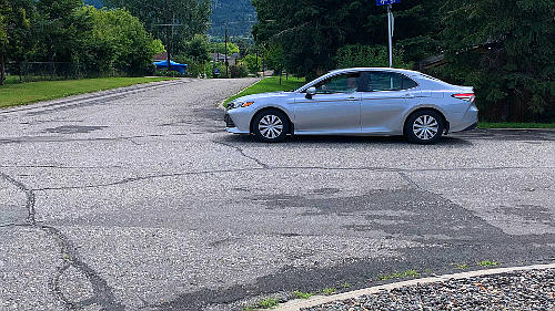 If there isn't a STOP line, and no sidewalk, stop your vehicle just before where the 2 roads meet at the edge of the intersection.