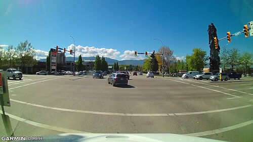 For the best defensive posturing when preparing to turn left, wait at the edge of the intersection to stay safe.
