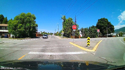 When waiting to turn left, stop with the front steer tires on the front crosswalk line. That way you're committed to the intersection, but not in the intersection if something goes wrong.