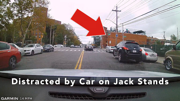 There are many distractions in a large city. Cars on jack stands along the road are just one of those distractions.